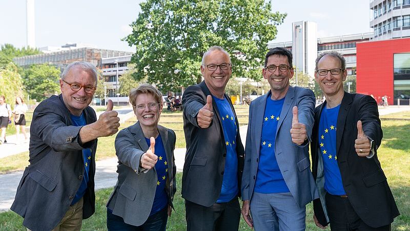 Rektoratsmitglieder halten Daumen nach oben.